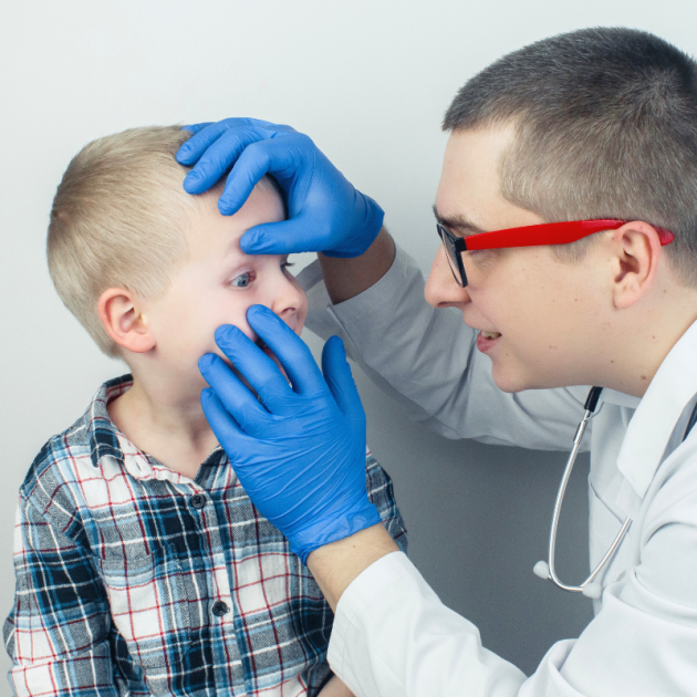 A doctor examining a child's eyes.