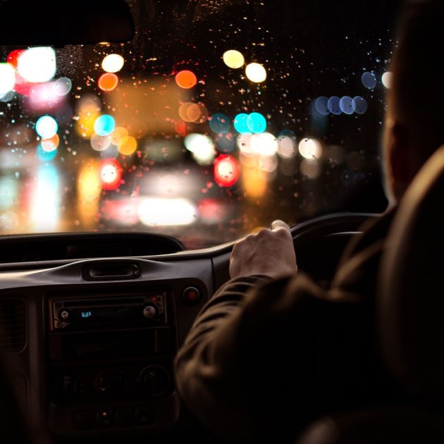 Man driving at night in glasses