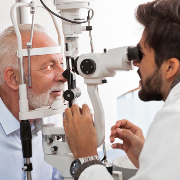 An optometrist examining a patient's eye.