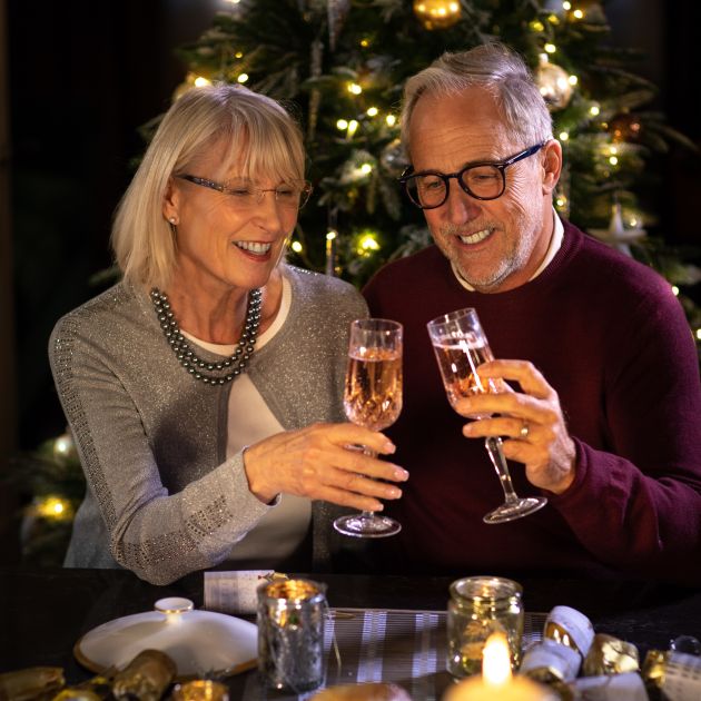 husband and wife champagne toast christmas