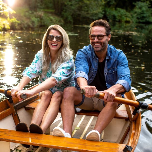 Couple rowing a boat.