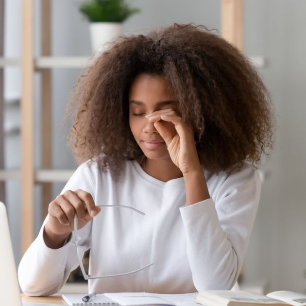 A woman rubbing her eye.