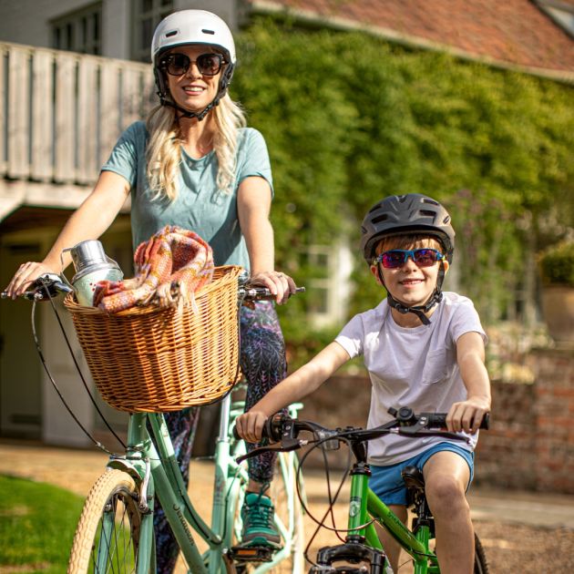 Mum and son riding bikes, wearing sunglasses
