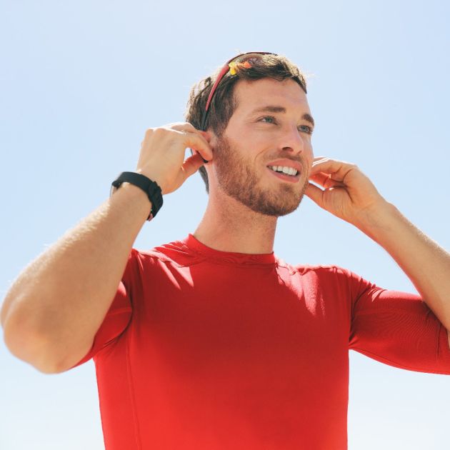 Man ready for a run with hearing aids