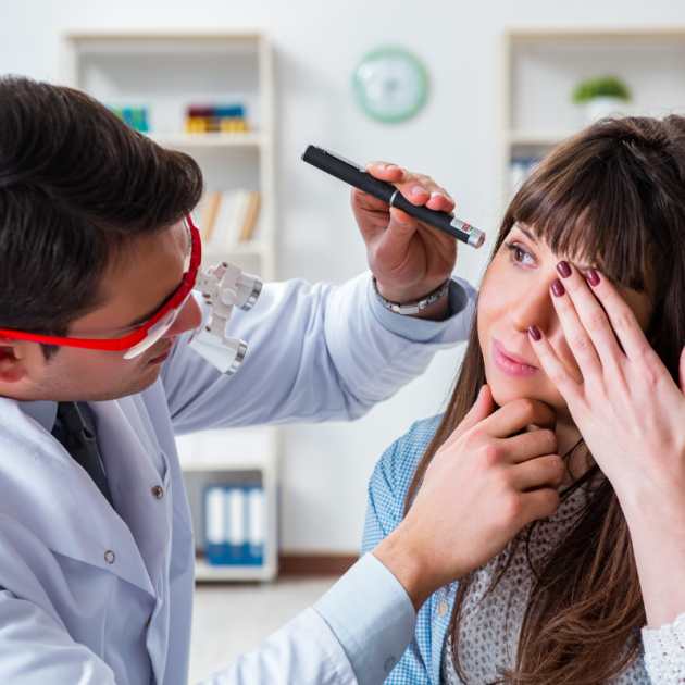 Doctor examining patients eye in hospital.