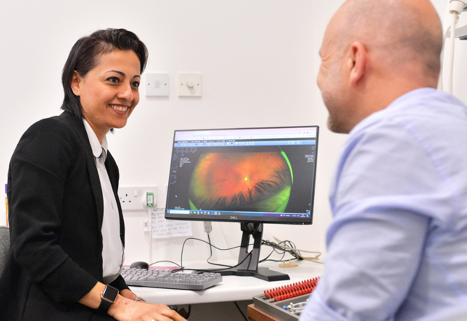 An optometrist with a patient during an appointment.