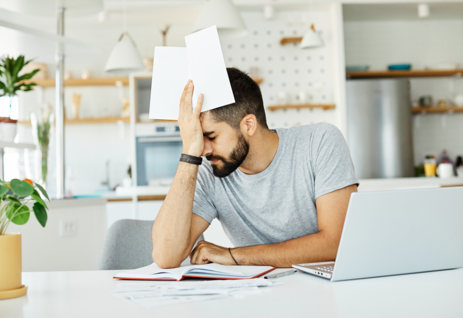 A man with visual stress having a headache while trying to read.