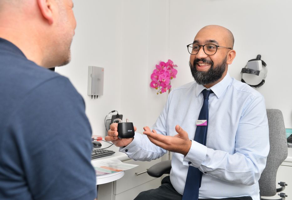 Audiologist discussing hearing aids with a patient as a solution for hearing loss.