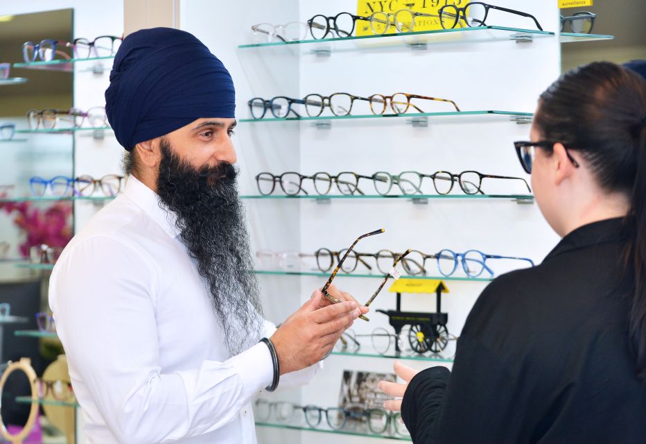 An optician assisting a patient in selecting the perfect eyewear, offering personalised recommendations and showcasing various frame options.