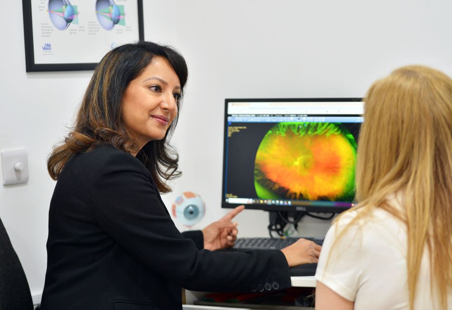 An optometrist with a patient during an appointment.