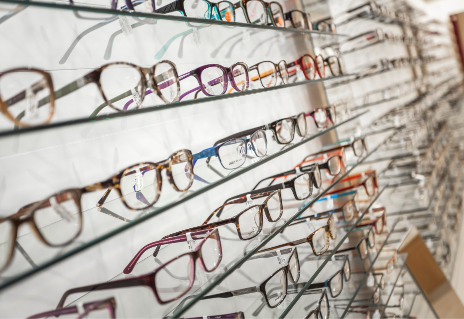 Shelves filled with a diverse selection of glasses, showcasing various styles, colors, and designs for eyewear enthusiasts.