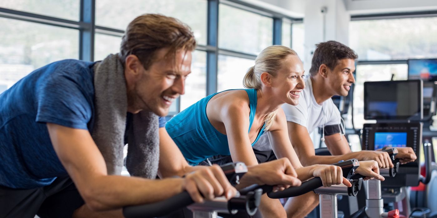 friends in gym on fixed bikes