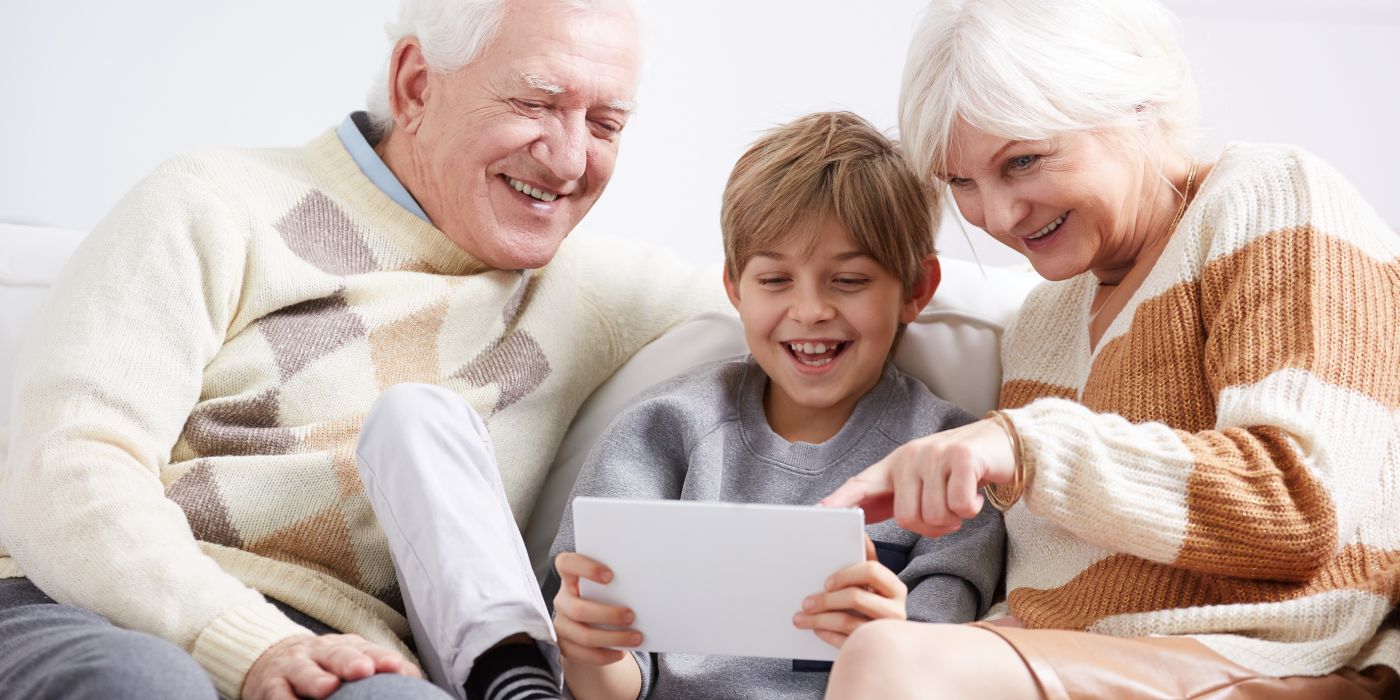 Grandparents with grandchild on ipad