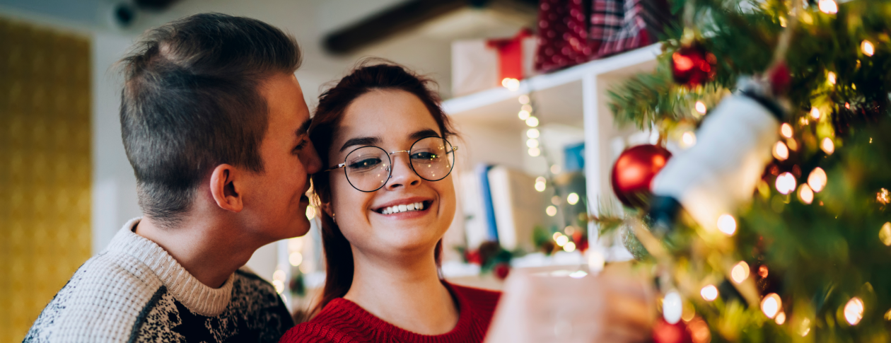 Couple decorating the Christmas tree