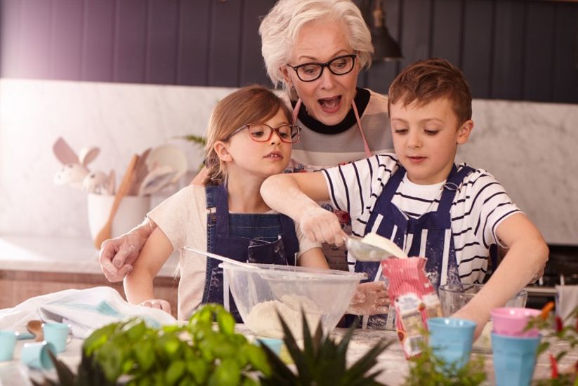 children and grandmother baking