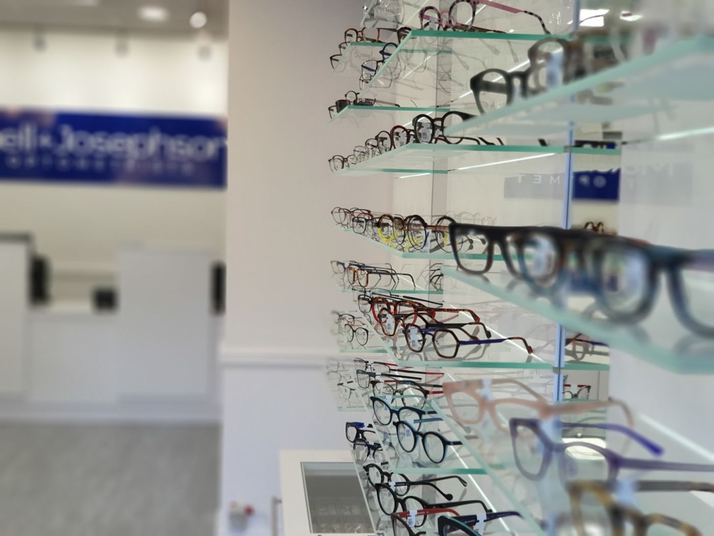 Blurred image of glasses on display in opticians