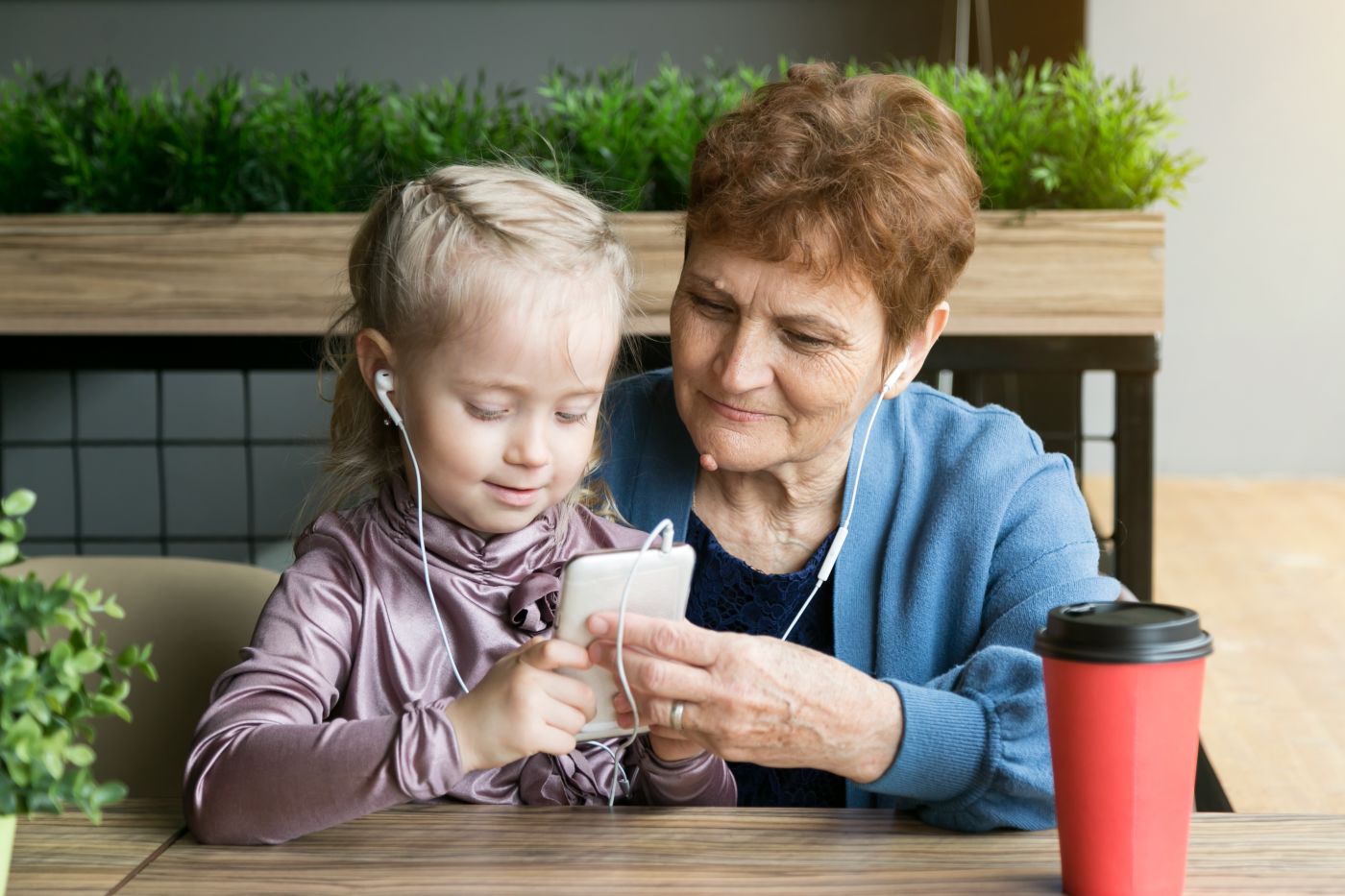 girl and grandma using headphones