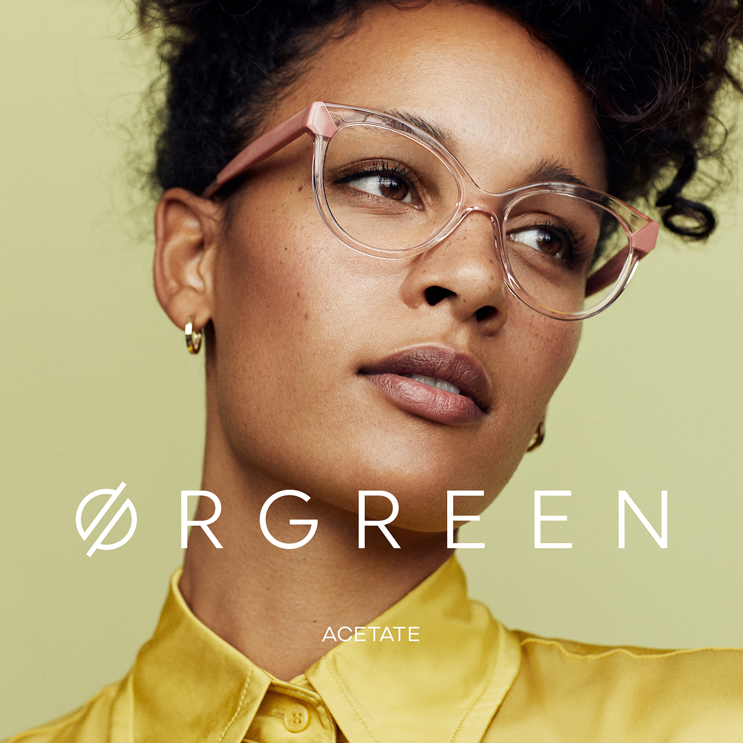 Orgreen acetate campaign poster featuring a woman wearing glasses with a yellow shirt.