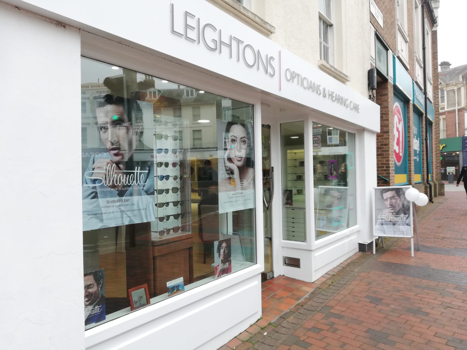 Front of Leightons Tunbridge Wells branch with Silhouette posters on their windows.