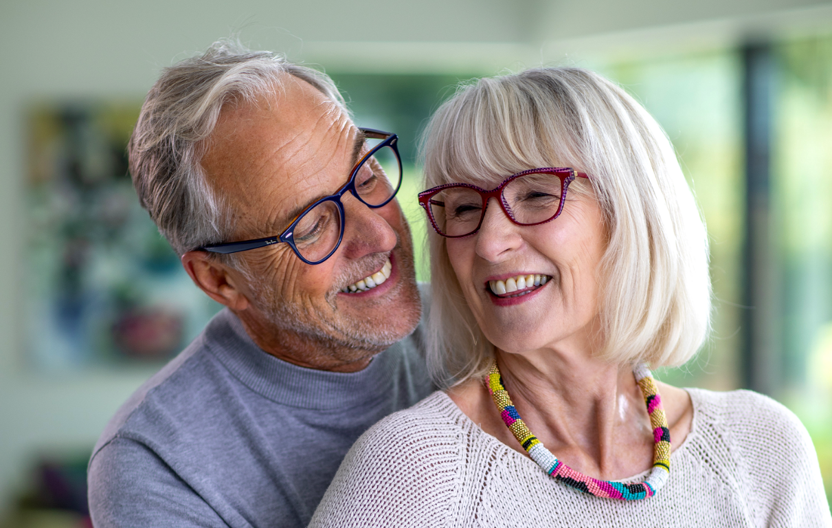 Happy older couple together in the kitchen.