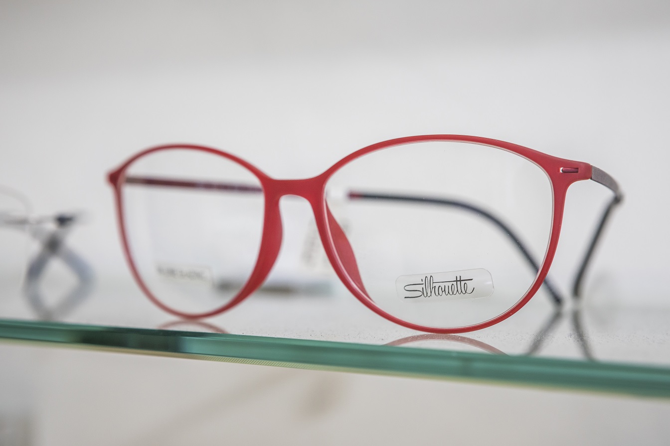 A red Silhouette glasses frame.