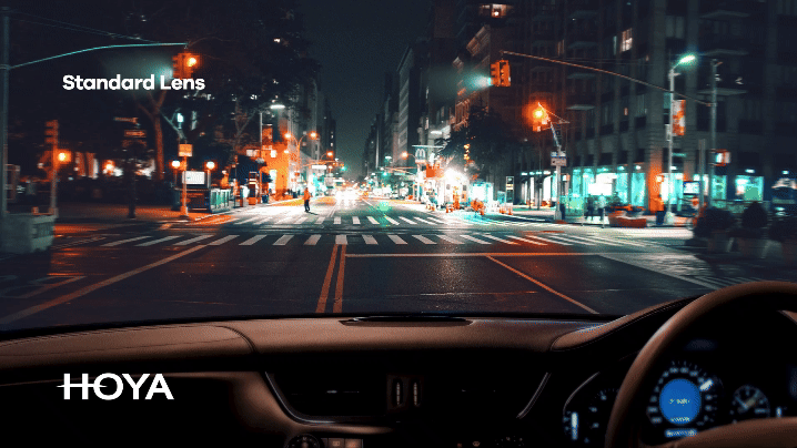 Animated comparison of driving vision with standard lenses versus Hoya EnRoute lenses, highlighting reduced glare and improved clarity for nighttime driving.