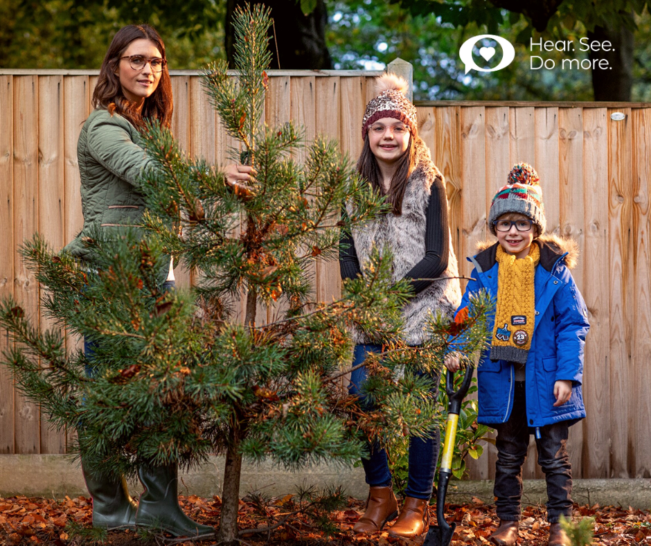 family planting a tree in winter