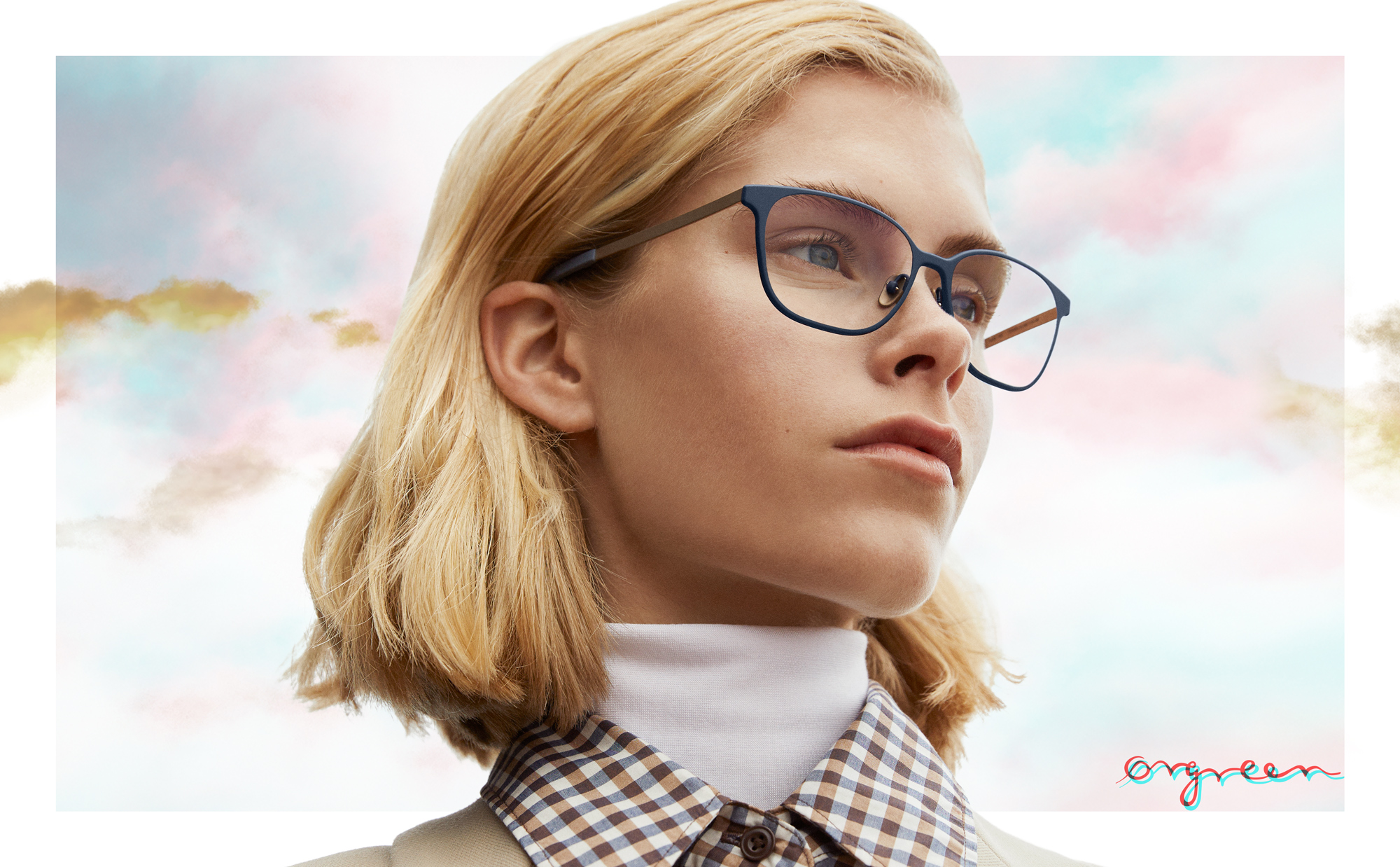 Ørgreen Titanium Collection campaign poster featuring a blonde woman wearing blue and thin glasses.