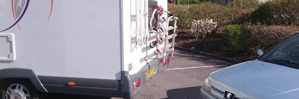 motorhome reveres into car
