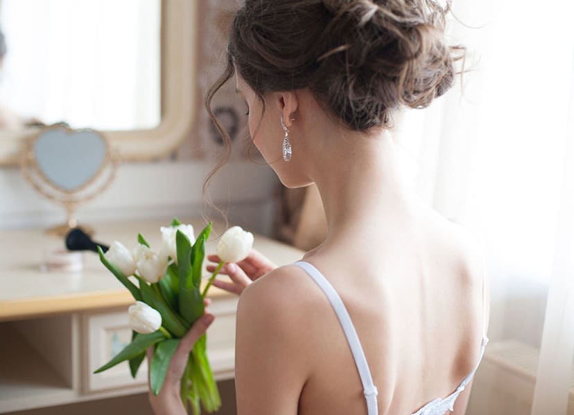 Woman in Wedding Dress holding Flowers