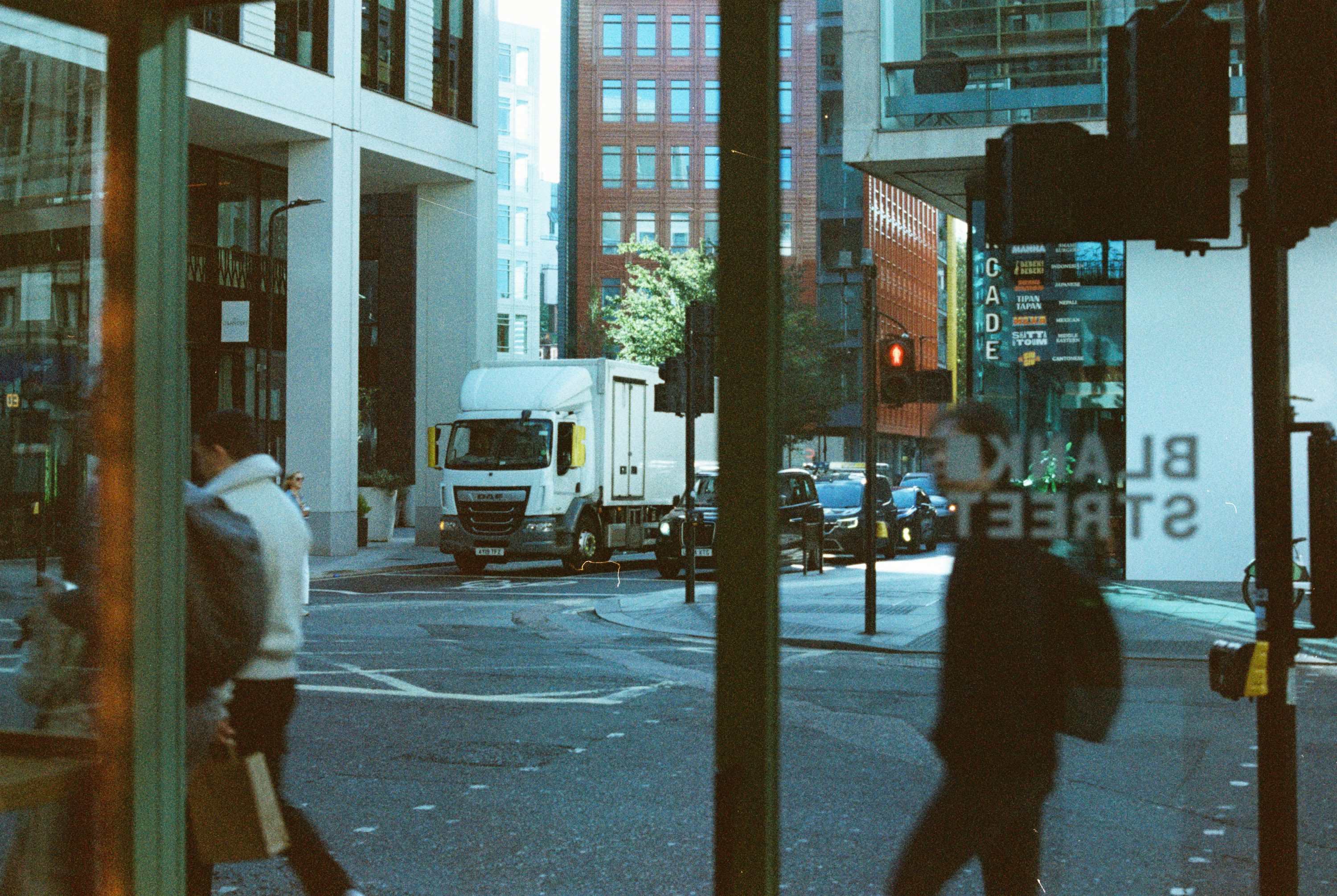 Delivery truck on a city street with pedestrians