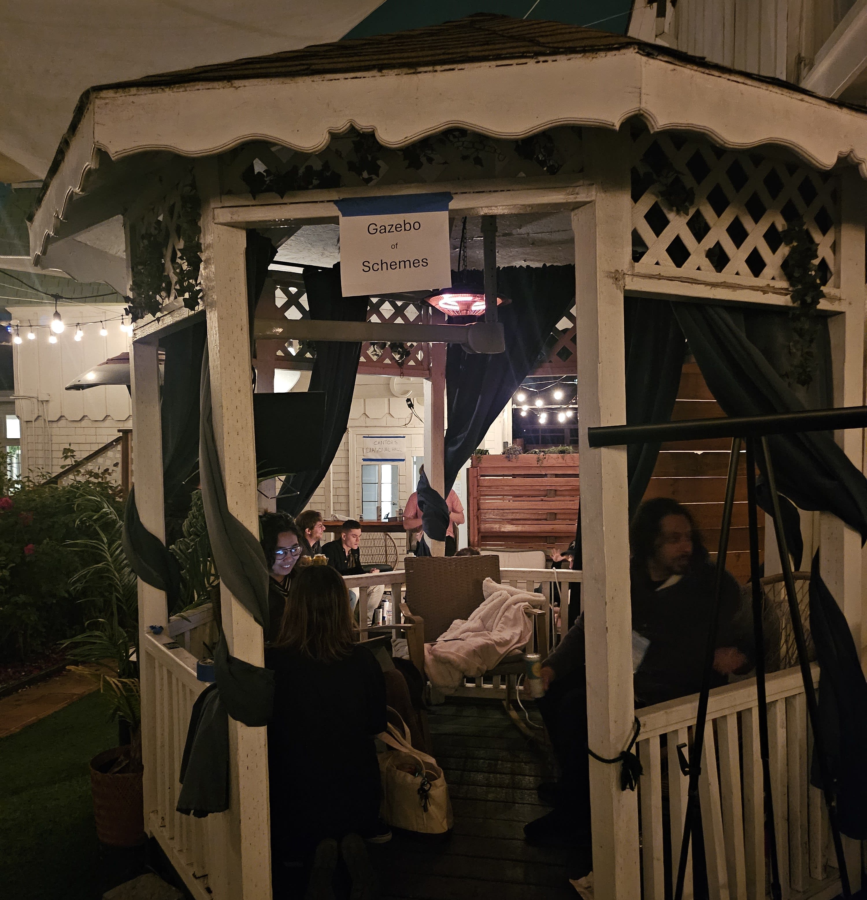 Hastily-Printed "Gazebo of Schemes" Duct-Taped to a lovely Lighthaven Gazebo