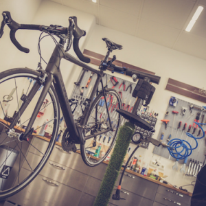 Photo of a bicycle in a repair shop by Alexander Dummer via Canva