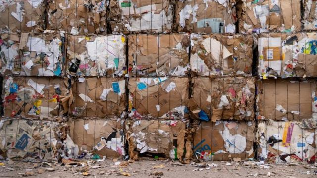 Photo of bales of cardboard and paper by Alex Fu via Canva