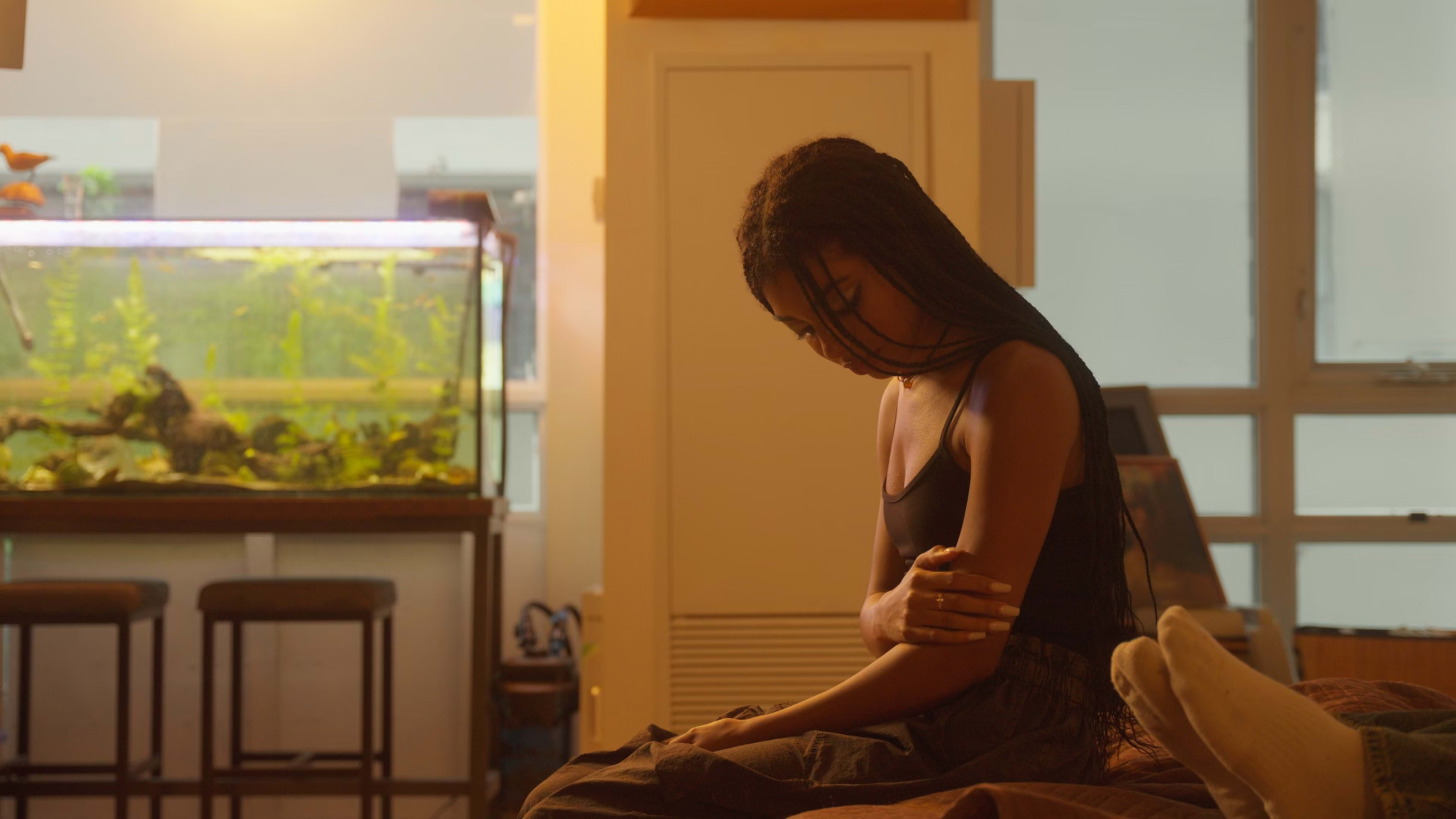A despairing teenage girl sitting on the bed