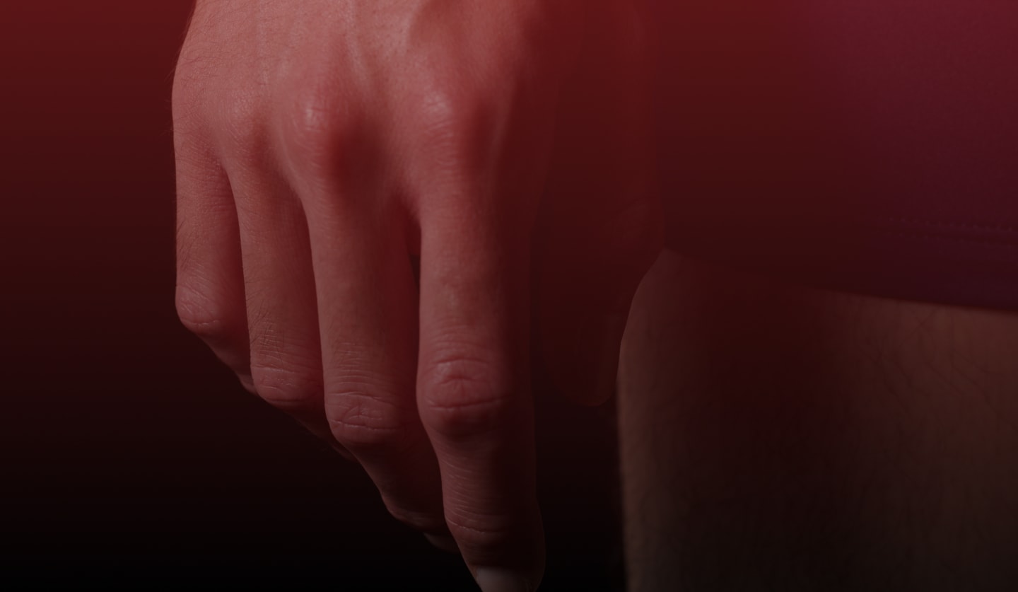 A man's hand is shown on a black background.