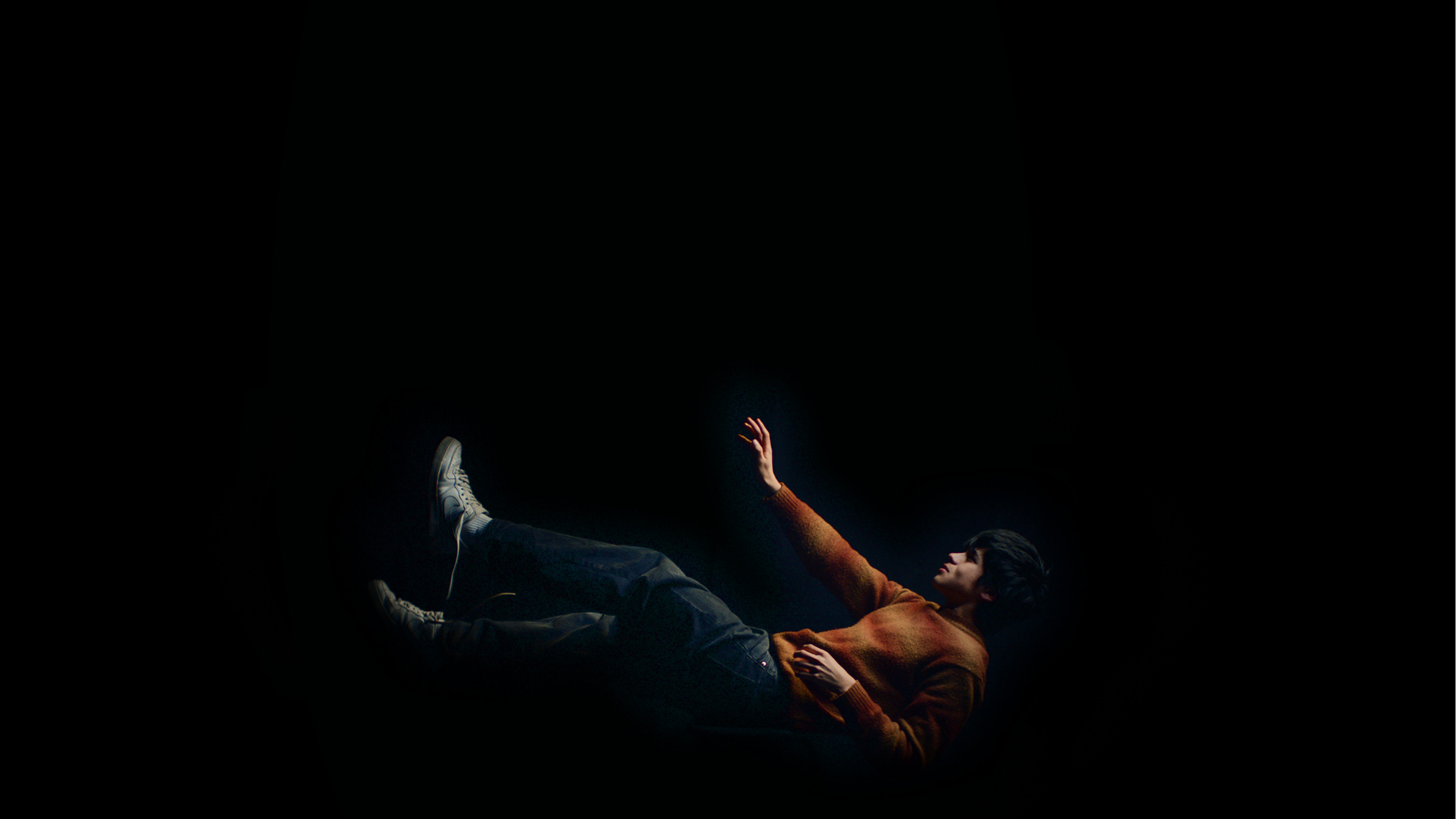 A guy in a laying position, seems to be falling