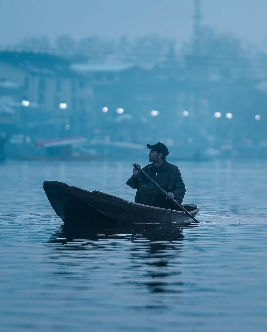Houseboats on Dal Lake beneath snow-covered mountains, Srinagar, Kashmir
