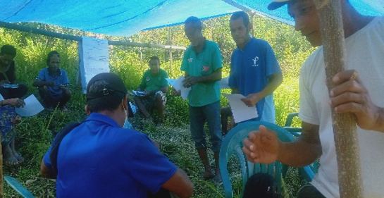 Community members meeting in the field with FUNDAMOR staff to discuss climate adaptation.