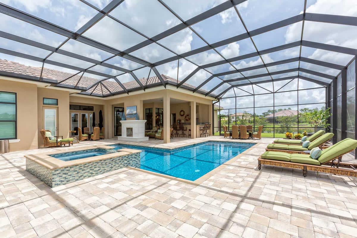 https://res.cloudinary.com/liaison-inc/image/upload/f_auto/q_auto%2Cw_1200/v1658518954/content/homeguide/homeguide-florida-pool-cage-screen-with-gable-roof-hot-tub-and-patio-furniture_m04kxw.jpg