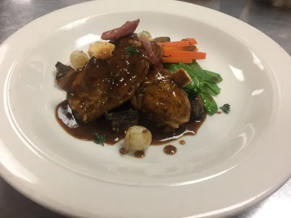 Chicken and gravy with snow peas, roasted carrots and pearl onions