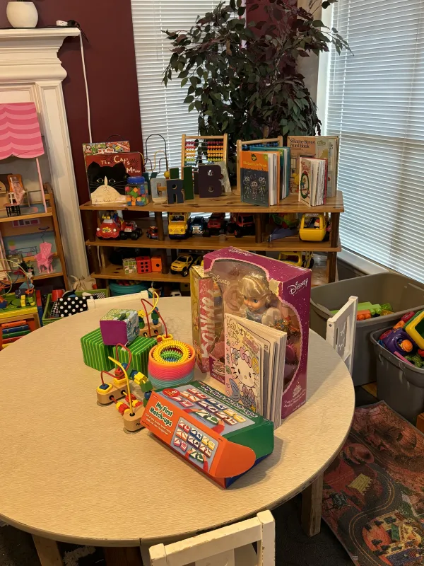 Table with chairs and different toys.