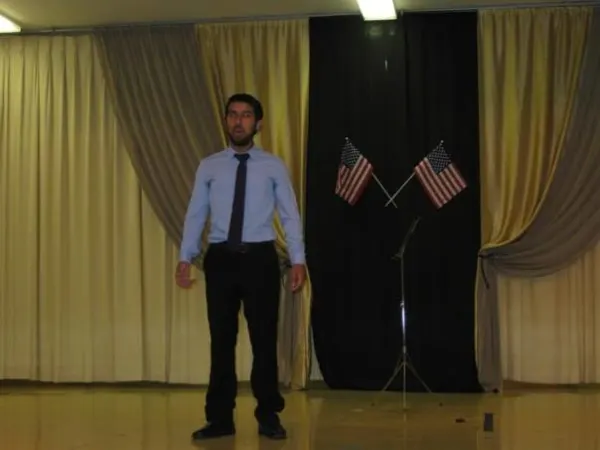 Mr. Alexis singing National anthem