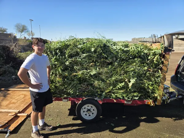 My son Anthony standing next to over 1600 lbs of weeds from St Catherine's Church