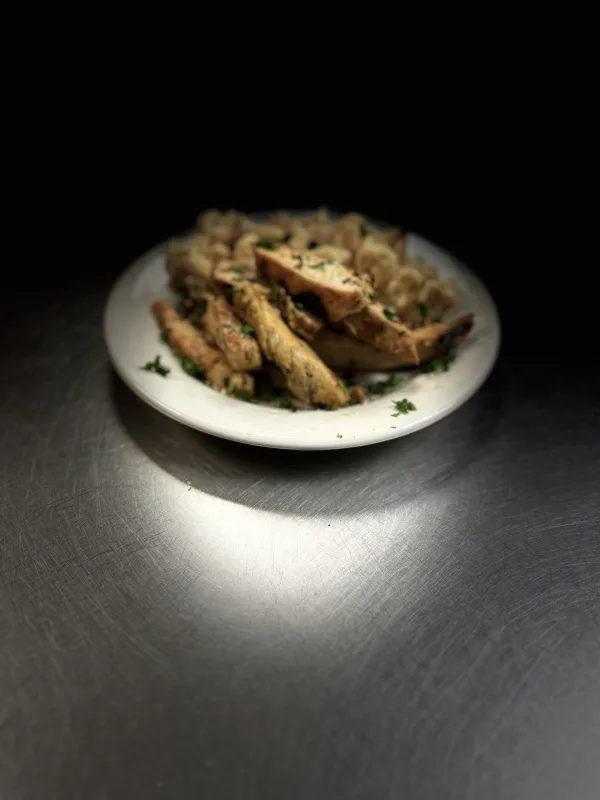 Baked lemon chicken with white cheddar Pasta garnish with fresh parsley