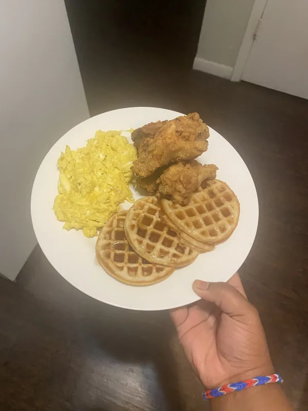 Homemade waffles with fried chicken wings and eggs