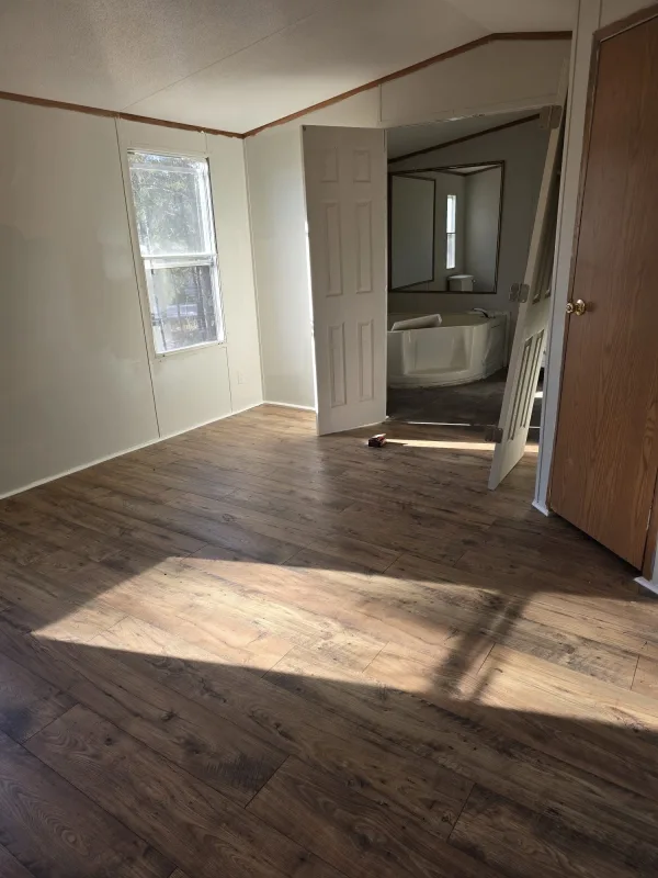 Full flooring installation in this room. We removed the previous flooring and installed new wood-look flooring throughout, giving the space a warmer, more modern appearance with a clean and seamless finish.