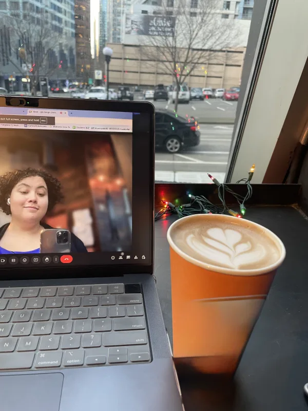 laptop with Carissa on screen and latte