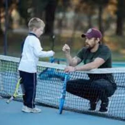 TENNIS COACH.