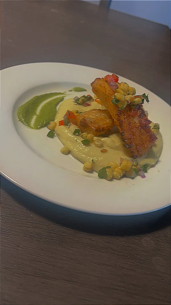 Cod fish with garlic mash topped with a corn salsa and poblano cream sauce